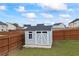 Storage shed in a fenced backyard, providing extra space for tools and equipment at 548 Azalea Bloom Drive E, Loganville, GA 30052