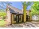 Side view of home with a two-car driveway and backyard with a lush green lawn and trees at 1074 Cherokee Hts, Stone Mountain, GA 30083