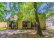 Backyard view of home with a patio, lawn, and mature shade trees at 1074 Cherokee Hts, Stone Mountain, GA 30083