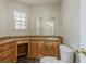 Bright bathroom featuring a sink with wood cabinets and drawers, a toilet, and a window at 1074 Cherokee Hts, Stone Mountain, GA 30083