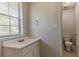 A bright bathroom features a vanity and toilet, illuminated by a window at 1074 Cherokee Hts, Stone Mountain, GA 30083