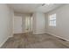 This bedroom features neutral walls, carpeted floors, and a window with blinds for natural light at 1074 Cherokee Hts, Stone Mountain, GA 30083