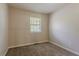 Carpeted bedroom featuring a window for natural light and neutral-colored walls at 1074 Cherokee Hts, Stone Mountain, GA 30083
