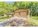 Detached two-car garage with a concrete driveway and manicured lawn at 1074 Cherokee Hts, Stone Mountain, GA 30083