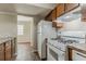 Functional kitchen design with white appliances and wood-toned cabinetry at 1074 Cherokee Hts, Stone Mountain, GA 30083