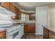 Cozy kitchen features wood cabinets, white appliances, and durable flooring at 1074 Cherokee Hts, Stone Mountain, GA 30083