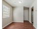 A simple living room is brightened by a large window and laminate floors at 1074 Cherokee Hts, Stone Mountain, GA 30083