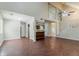 A spacious living room with high ceilings, a fan, wood floors and a staircase provides a grand ambiance at 1074 Cherokee Hts, Stone Mountain, GA 30083