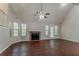 A bright living room with a fireplace, large windows, and wood floors offer a warm atmosphere at 1074 Cherokee Hts, Stone Mountain, GA 30083