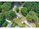 Aerial shot of the home highlighting the mature trees and landscaping enhancing the property's appeal at 232 Hembredge Dr, Canton, GA 30115
