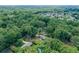 Wide aerial perspective showing the house nestled within a community with mature trees and landscaping at 232 Hembredge Dr, Canton, GA 30115