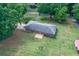 Aerial view showcasing the backyard, outdoor deck, spacious lawn, and mature landscaping on this home at 232 Hembredge Dr, Canton, GA 30115
