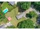 Aerial image shows a pool in a neighboring property, the home's large lot, and mature trees at 232 Hembredge Dr, Canton, GA 30115
