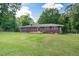 Extensive green backyard featuring a brick home, grassy lawn and beautiful mature trees at 232 Hembredge Dr, Canton, GA 30115