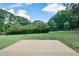Expansive backyard showcasing a well-maintained lawn, privacy fence and beautiful trees at 232 Hembredge Dr, Canton, GA 30115