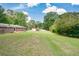 Scenic backyard view with a lush lawn, small storage shed and a cozy wooden deck at 232 Hembredge Dr, Canton, GA 30115