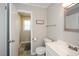 Well-lit bathroom featuring a sleek vanity, modern fixtures and grey tile flooring at 232 Hembredge Dr, Canton, GA 30115