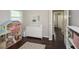 This Bedroom features hardwood floors, a doll house, dresser, and access to the hall at 232 Hembredge Dr, Canton, GA 30115