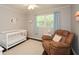 Bright Bedroom with a crib, chair, and window providing natural light at 232 Hembredge Dr, Canton, GA 30115
