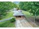 Charming home featuring a spacious backyard, covered patio, and a long driveway at 232 Hembredge Dr, Canton, GA 30115