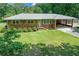 Charming brick home with a covered carport and a lush green lawn at 232 Hembredge Dr, Canton, GA 30115