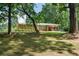 Brick home nestled among trees, showcasing its well-manicured front lawn at 232 Hembredge Dr, Canton, GA 30115