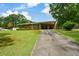Brick home featuring a covered carport and long driveway, set on a spacious lawn at 232 Hembredge Dr, Canton, GA 30115