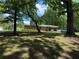 Traditional single story home with mature trees, and a covered carport at 232 Hembredge Dr, Canton, GA 30115