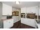 Bright kitchen featuring white cabinets, stainless steel appliances, and dark hardwood floors at 232 Hembredge Dr, Canton, GA 30115