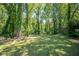 Spacious grassy backyard surrounded by mature trees, ideal for outdoor activities and relaxation at 2755 Rockcliff Se Rd, Atlanta, GA 30316