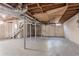 Unfinished basement with exposed ductwork, concrete floors and walls, and supporting beams at 2755 Rockcliff Se Rd, Atlanta, GA 30316