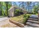 Two-story house with gray brick, garage, steps, lawn, and mature trees at 2755 Rockcliff Se Rd, Atlanta, GA 30316