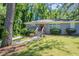 Charming single-story home features a gray brick exterior, green lawn and a red front door at 2755 Rockcliff Se Rd, Atlanta, GA 30316