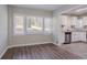 Open kitchen area features white cabinets, stainless appliances and beautiful gray laminate floors at 2755 Rockcliff Se Rd, Atlanta, GA 30316