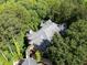 Breathtaking aerial view of a house surrounded by lush forest offering privacy and tranquility at 301 Mill Pond Se Ct, Smyrna, GA 30082