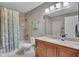 Bathroom featuring tile flooring, a granite vanity, a shower-tub combo, and a toilet at 301 Mill Pond Se Ct, Smyrna, GA 30082