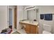 Bathroom featuring wooden cabinets, white countertops, with a large mirror and ample lighting at 301 Mill Pond Se Ct, Smyrna, GA 30082