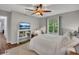 Comfortable bedroom with wood-look flooring, ceiling fan, and natural light at 301 Mill Pond Se Ct, Smyrna, GA 30082