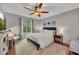 Cozy bedroom with a ceiling fan, and a large window providing natural light at 301 Mill Pond Se Ct, Smyrna, GA 30082