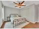 Bedroom with a metal bed frame, wood-look flooring, ceiling fan, and lots of natural light at 301 Mill Pond Se Ct, Smyrna, GA 30082