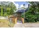 Charming home with a wooden ramp, mature trees, and a well-manicured landscape at 301 Mill Pond Se Ct, Smyrna, GA 30082