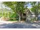 Beautiful house featuring a covered porch surrounded by lush greenery and tall trees at 301 Mill Pond Se Ct, Smyrna, GA 30082