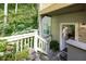 Charming home exterior featuring a porch entrance with lush greenery surroundings and a wooden railing at 301 Mill Pond Se Ct, Smyrna, GA 30082