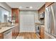 Traditional kitchen featuring wood cabinetry, stainless steel appliances, and a large double-door pantry at 301 Mill Pond Se Ct, Smyrna, GA 30082
