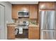 Modern kitchen features stainless steel appliances, ample countertop space, and wooden cabinetry at 301 Mill Pond Se Ct, Smyrna, GA 30082