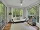 Bright sun room featuring lots of windows and a cozy seating area at 301 Mill Pond Se Ct, Smyrna, GA 30082