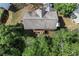 Aerial view of rooftop and back deck surrounded by mature trees and lush landscaping at 531 Chadborn Ct, Lawrenceville, GA 30045