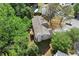 Home aerial view showing backyard, mature trees, lush green landscaping and neighborhood pool at 531 Chadborn Ct, Lawrenceville, GA 30045