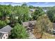 Aerial view of a brick home nestled among lush trees in a residential neighborhood at 531 Chadborn Ct, Lawrenceville, GA 30045