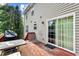 Outdoor deck area with gray siding, dining furniture, and glass sliding doors at 531 Chadborn Ct, Lawrenceville, GA 30045